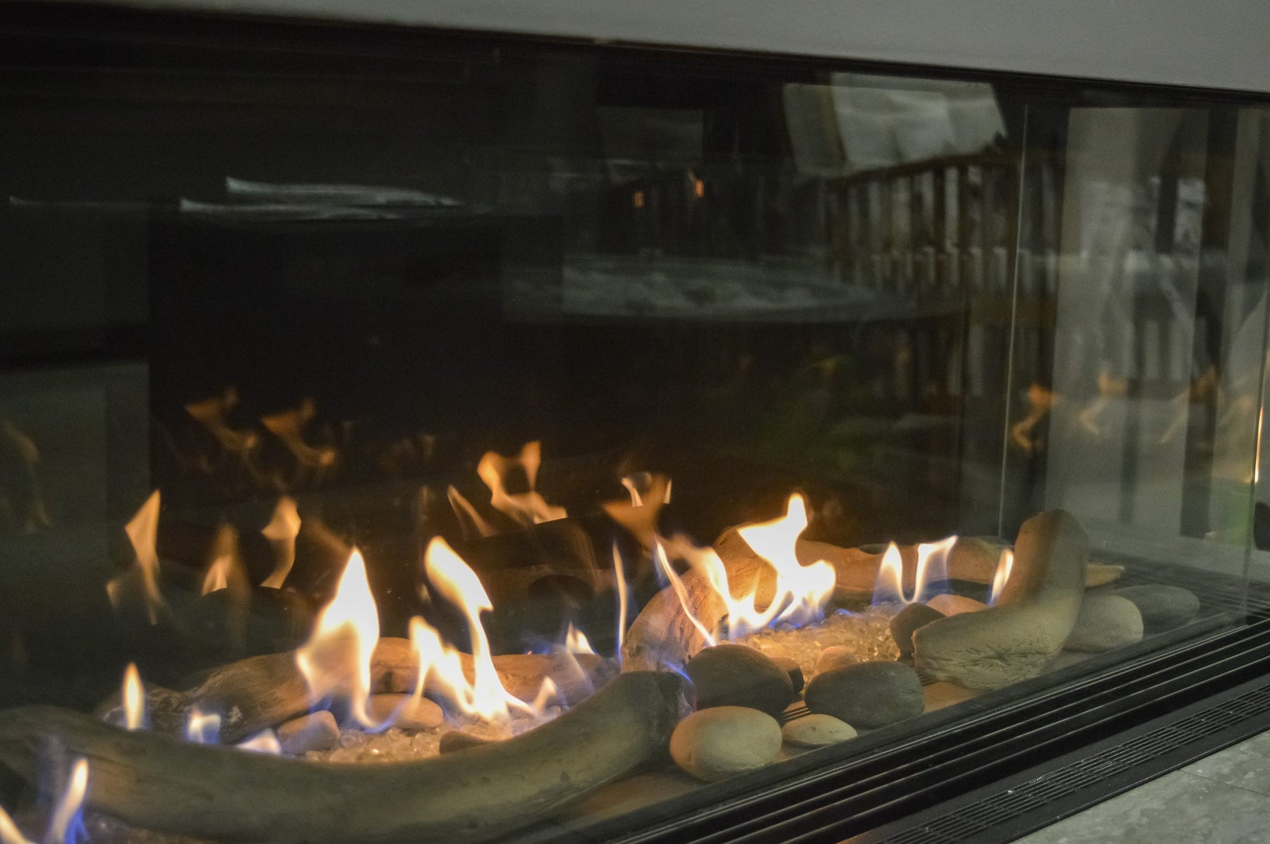 Sierra Flame Toscana 3-sided peninsula gas fireplace in a modern interior living space