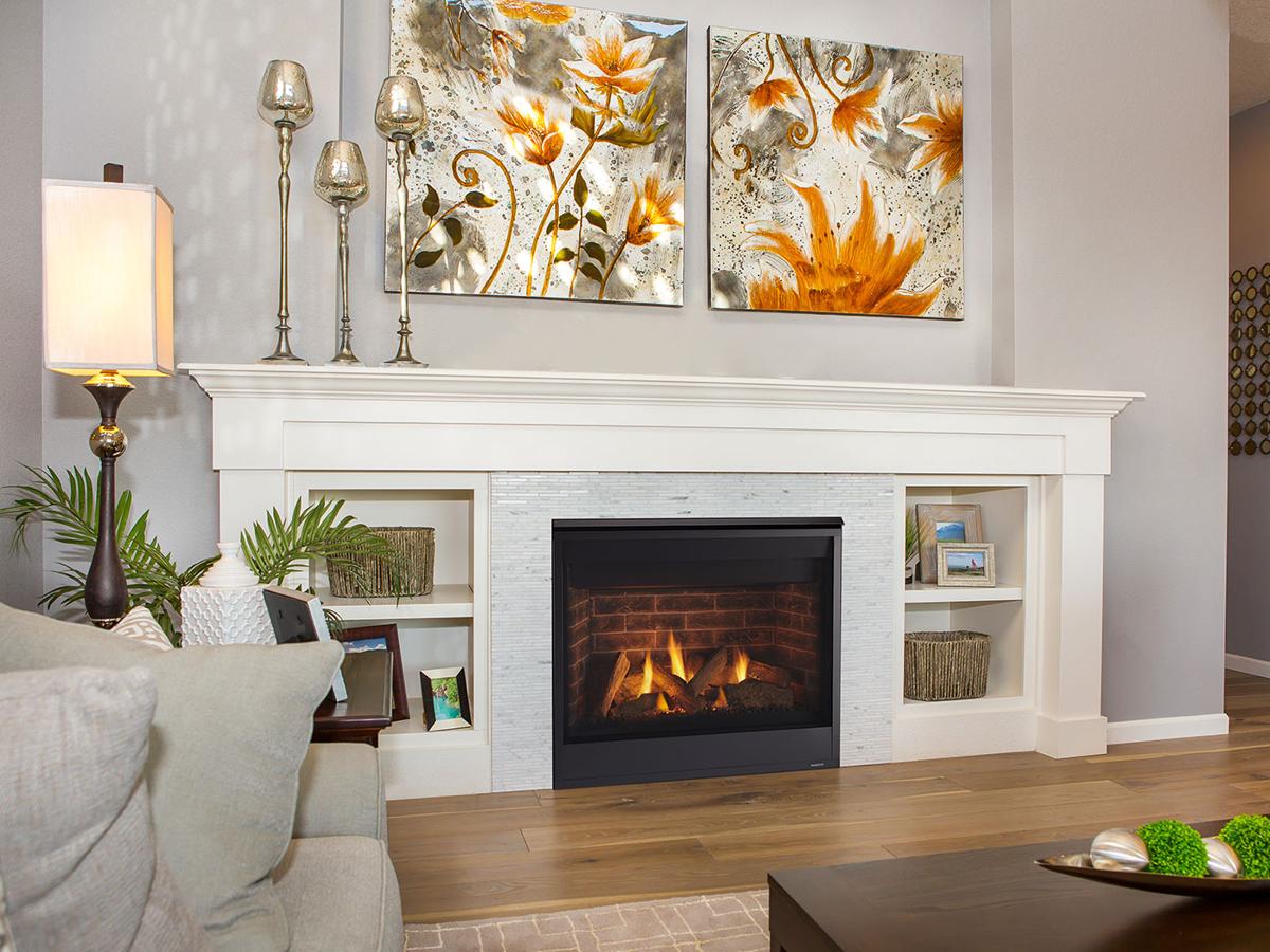 Gas fireplace burning with blue and yellow flame in a living room mantel