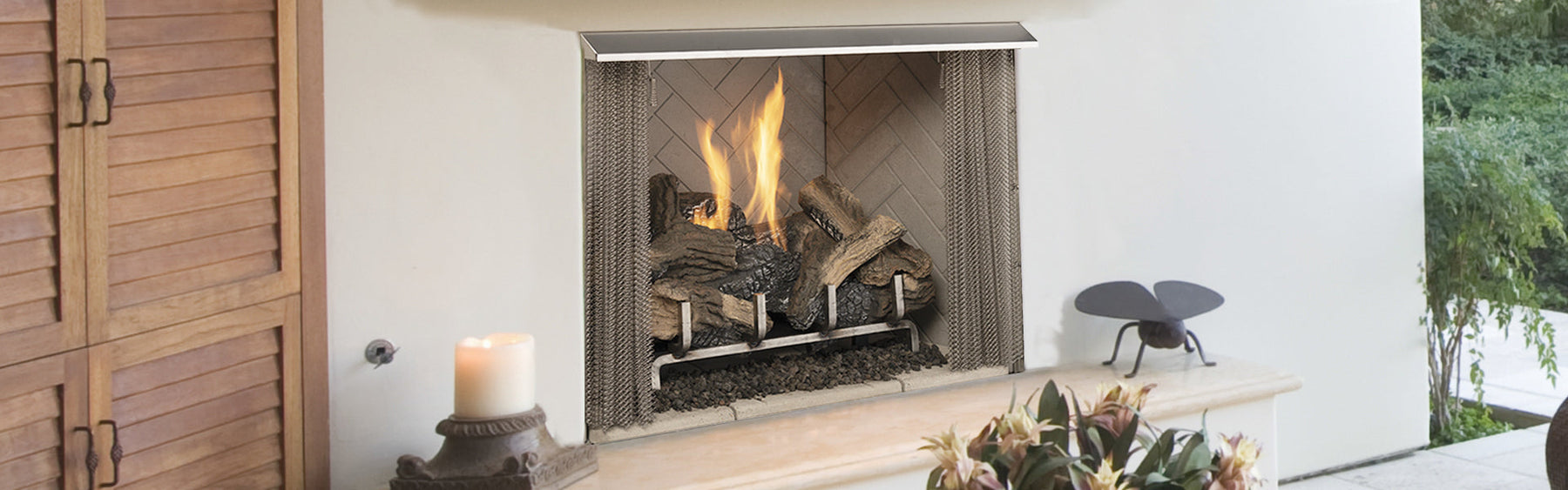 Superior VRE3200 vent-free outdoor gas fireplace installed in a covered outdoor living space with stone surround