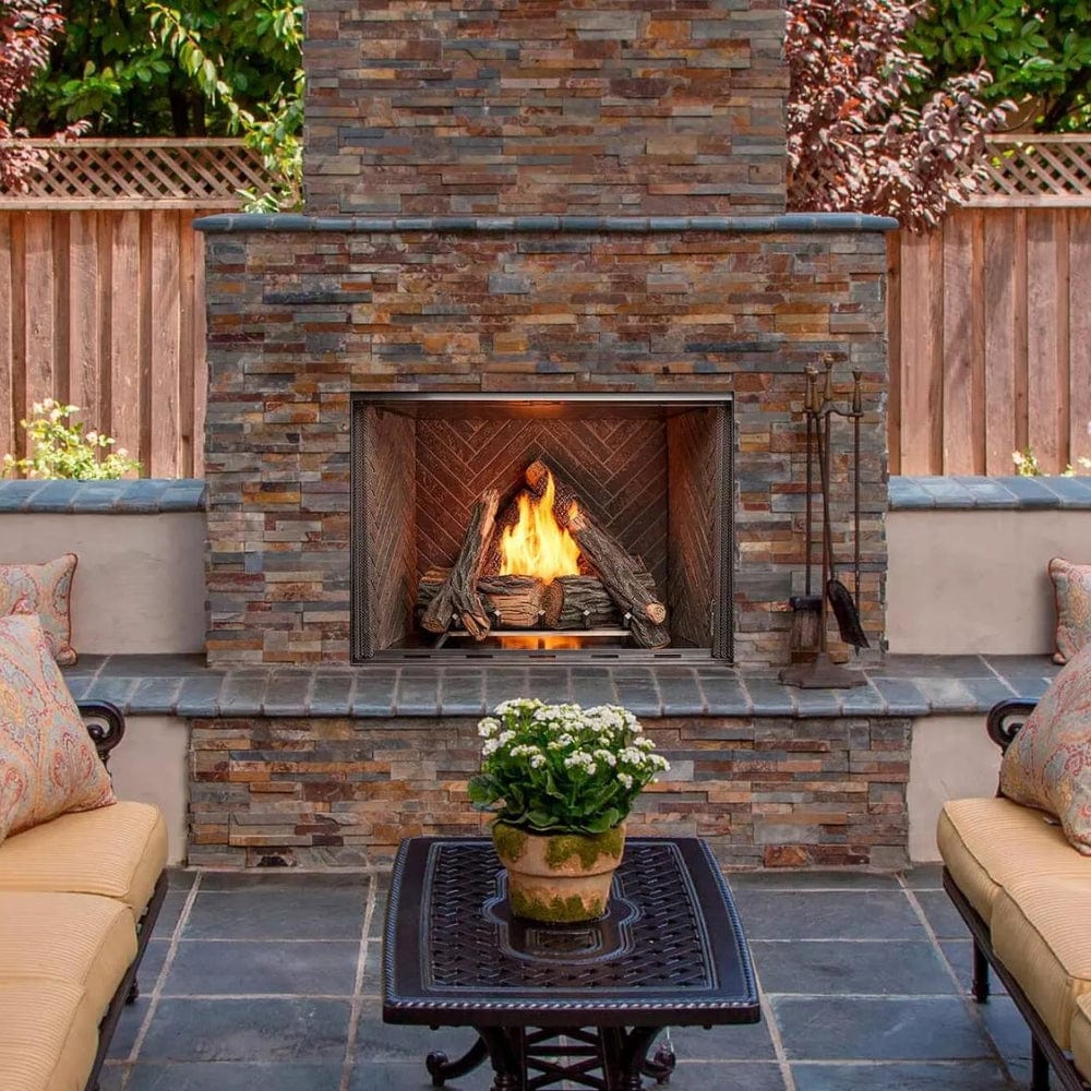 Majestic Courtyard outdoor gas fireplace installed in stacked slate outdoor surround with patio seating