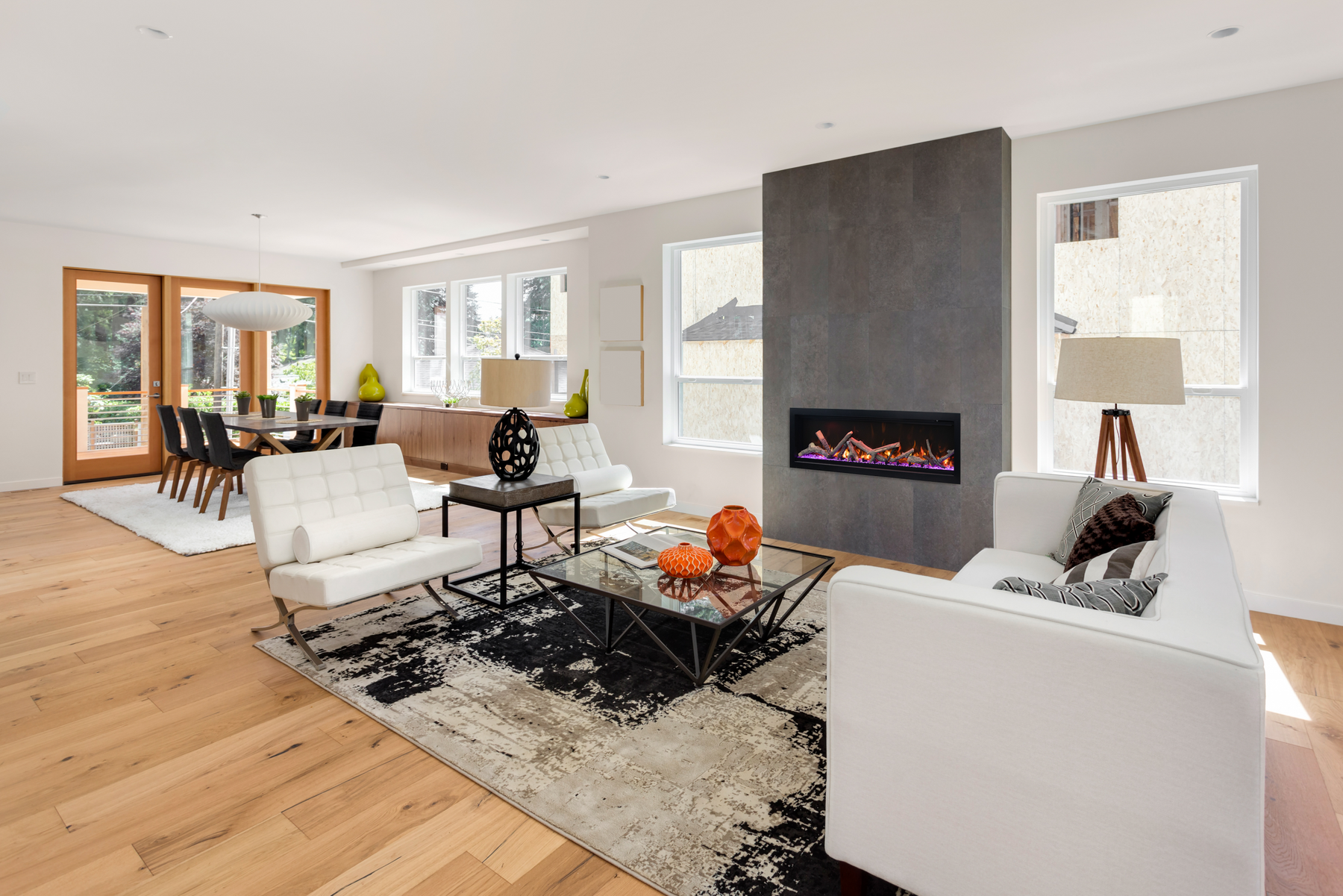Amantii Symmetry Bespoke 60 electric fireplace installed in a mid-century modern open-plan living room with oak log set